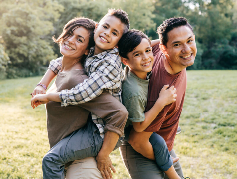 Family dressed in different color clothes taking picture in field